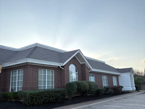 Wide view of a commercial property with refreshed beds and clean parking edges